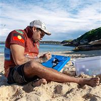 Man painting on the beach