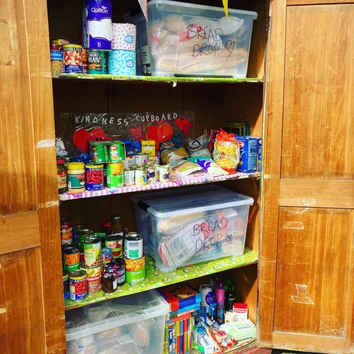 A cupboard filled with free groceries - for anyone who needs them