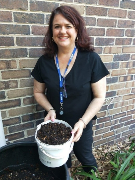 Staff member with compost