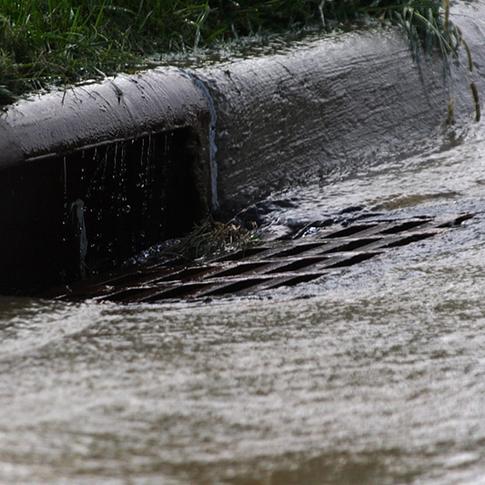 Storm water running down a street drain