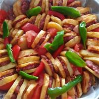 Eggplant, tomato and potato with mince beef place in circular pattern in baking dish