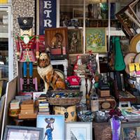 Various vintage household items on display in front of a store