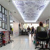 Interior of a tattoo studio, with illustrated patterns on the ceiling