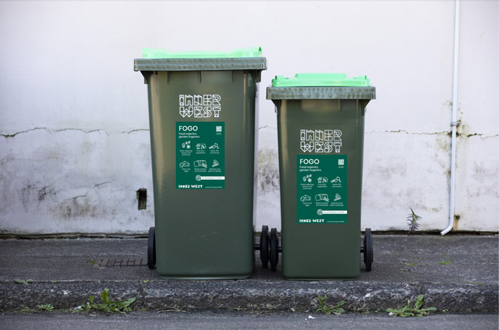 One large and one small green-lidded bin each labelled FOGO.