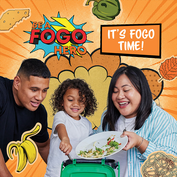 A family of three tipping food scraps from a plate into a countertop kitchen caddy.
