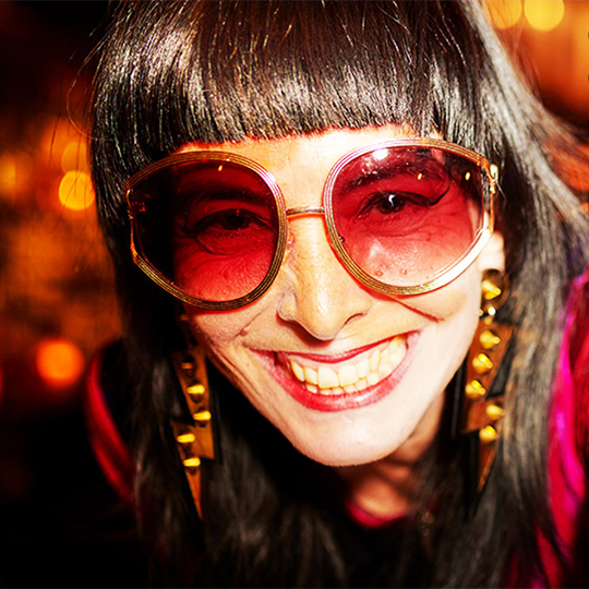 A smiling woman with large sunglasses