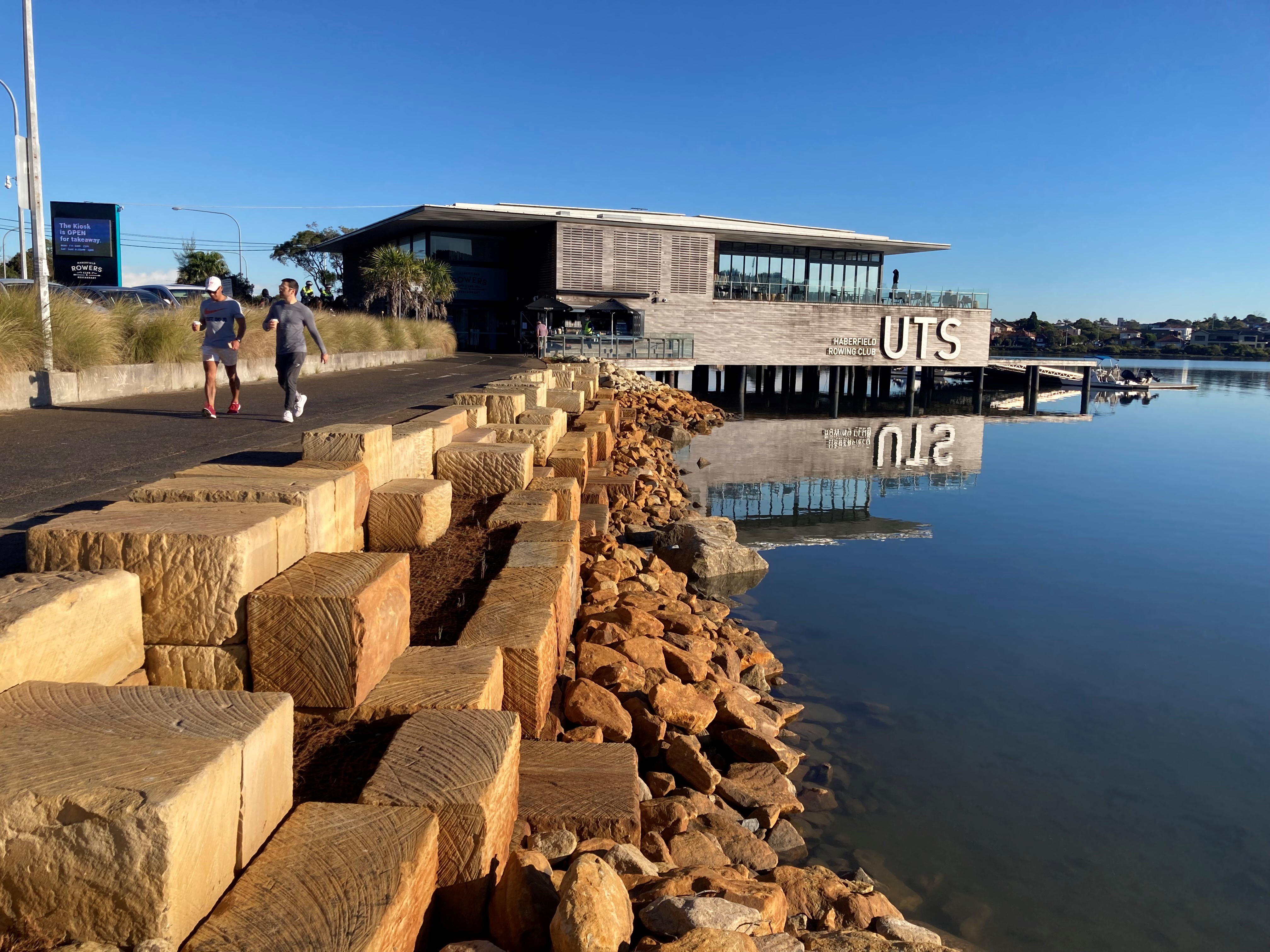 Dobroyd Point Seawall with new sandstone steps, with UTS Haberfield Rowing Club in the background