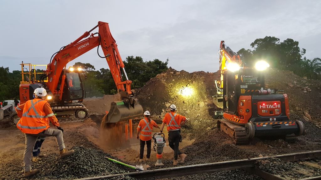 Cranes moving dirt as part of construction of the high voltage feeder