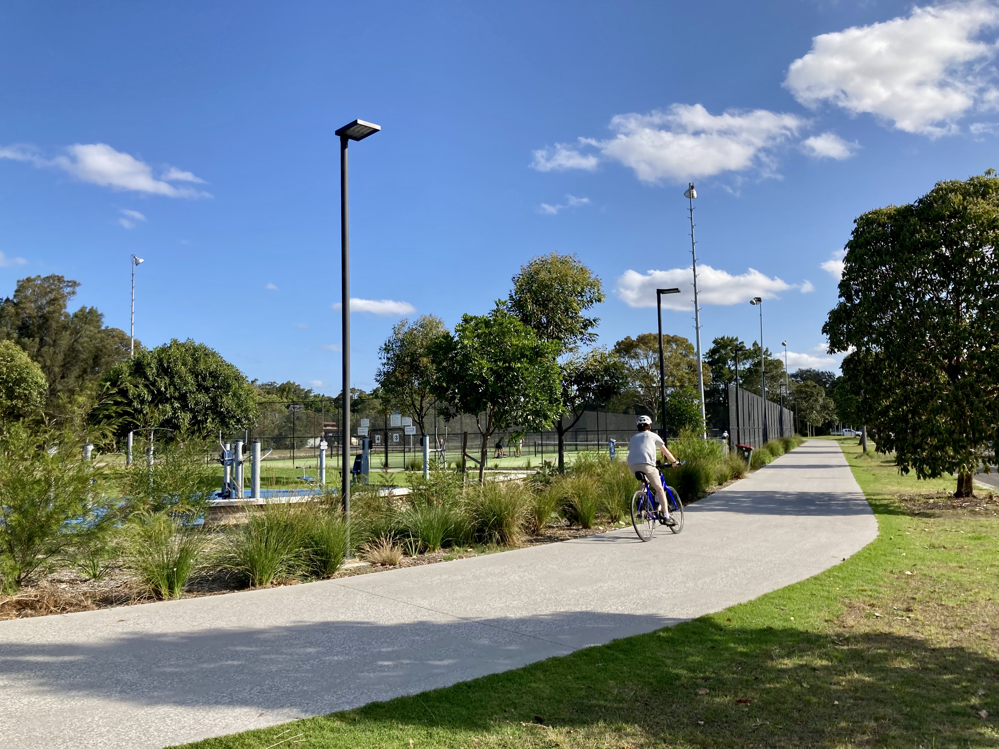 Someone cycling along the upgraded path at Richard Murden Reserve