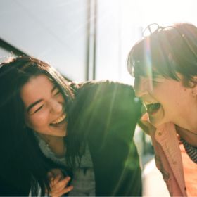 Two young people laughing together