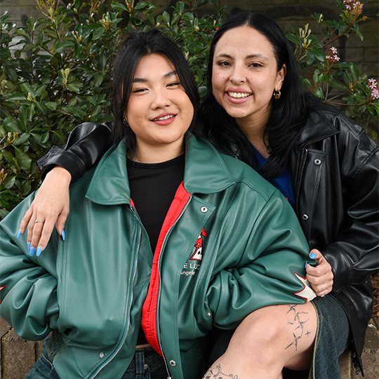 The women hugging looking at the camera