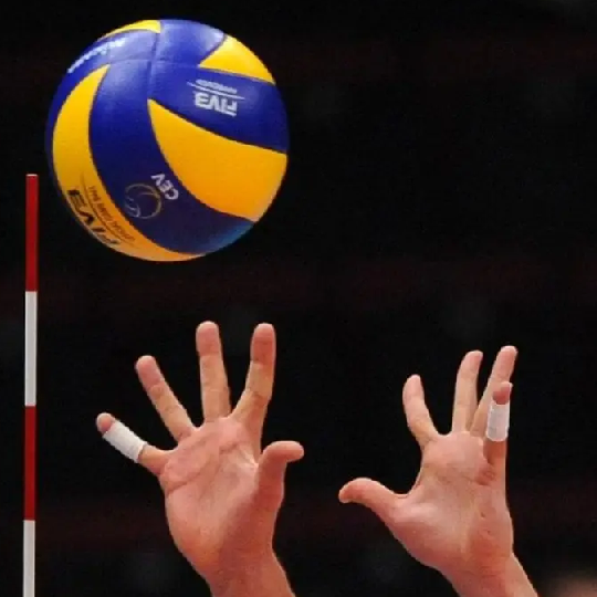 Hands reaching up to catch volleyball in the air