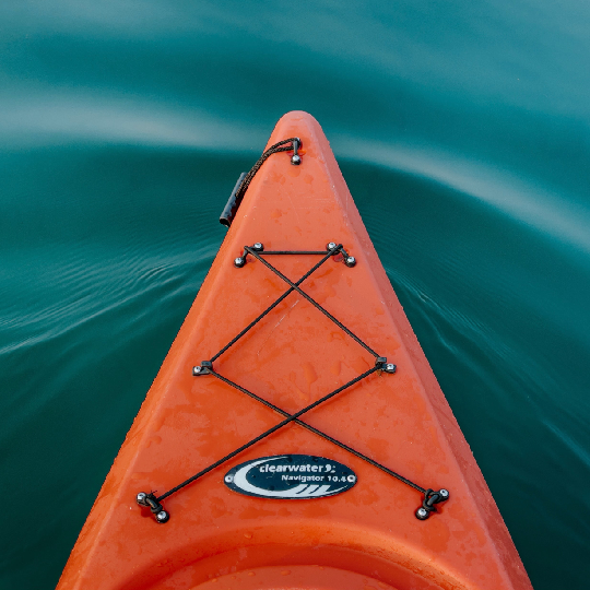  Front end of an orange kayak moving through water