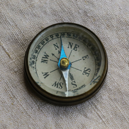  Compass sitting on a cloth material background