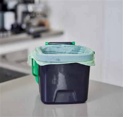 black and green benchtop food scraps bin