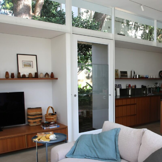 Interior of a house with rectangular windows around the edge of the ceiling