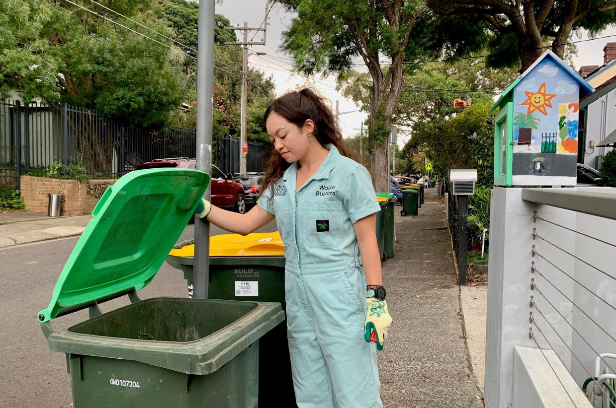 Waste Buster inspecting green FOGO bin