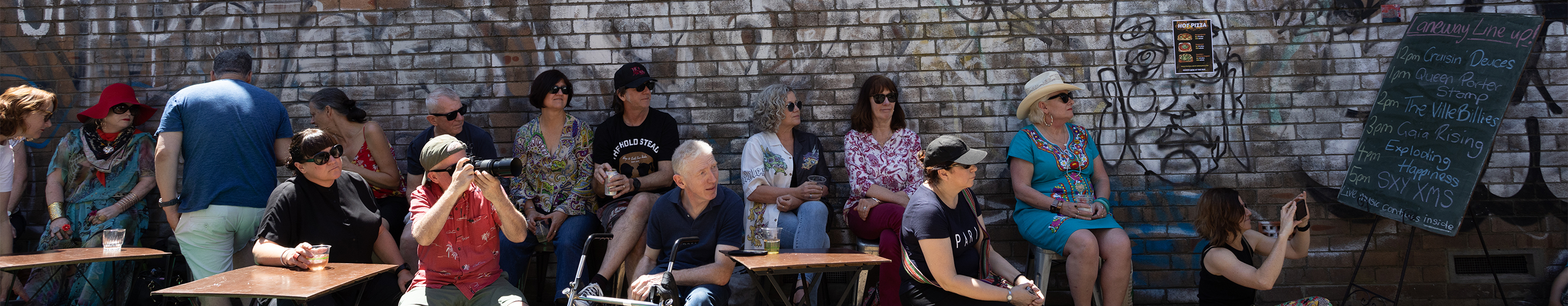 a group of people sitting in a laneway