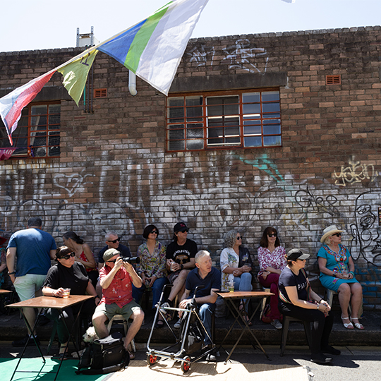 a group of people sitting in a laneway