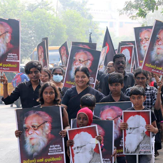 Group of smiling protesters holding placards