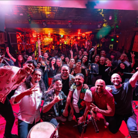 Colombian band pose on the stage in front of audience
