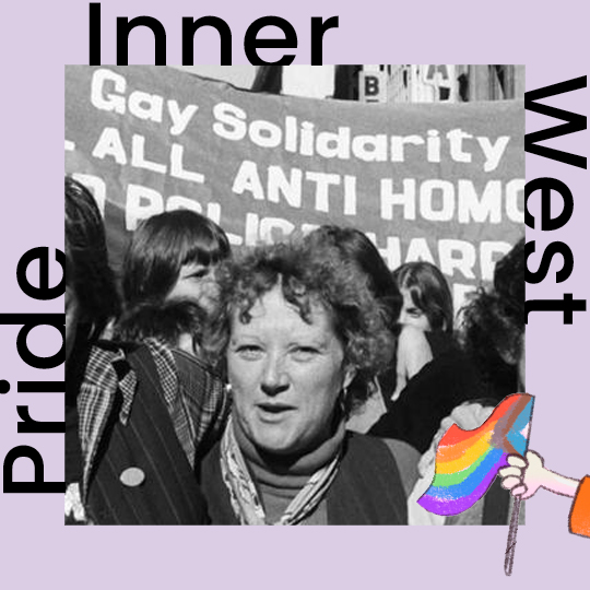 A black and white photograph of a woman standing in front of a banner reading 'Gay Solidarity'