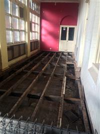Timber floor removed from verandah of heritage ward building – ground floor