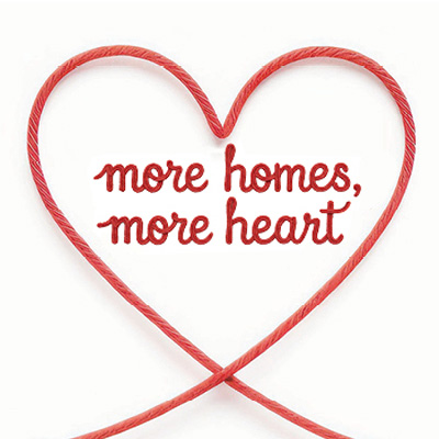 A thin red string or ribbon which forms the shape of a heart at one point. Inside the heart is the text 'More Homes, More Heart'