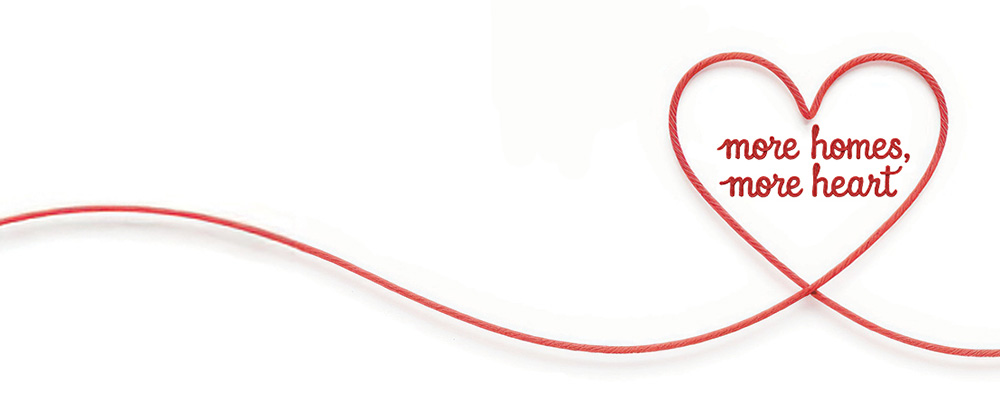 A thin red string or ribbon which forms the shape of a heart at one point. Inside the heart is the text 'More Homes, More Heart'