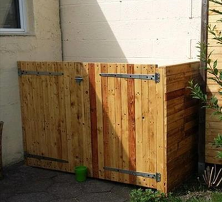 An example of a bin storage area with a wooden brown fence