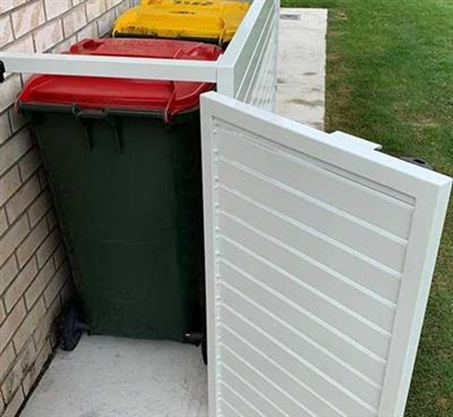 An example of a bin storage area behind a white gate