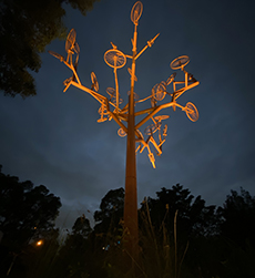a sculpture of a tree made of recycled bicycle parts to form a tree canopy