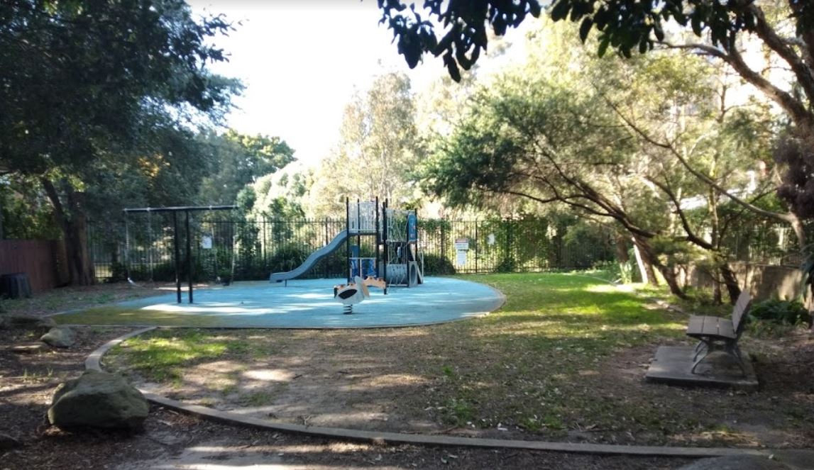 an image of a park showing seats and playground